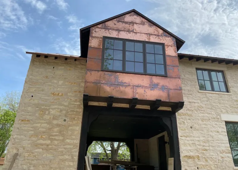 Copper metal panel facade on a stone building for Skylight Installation in Malverne
